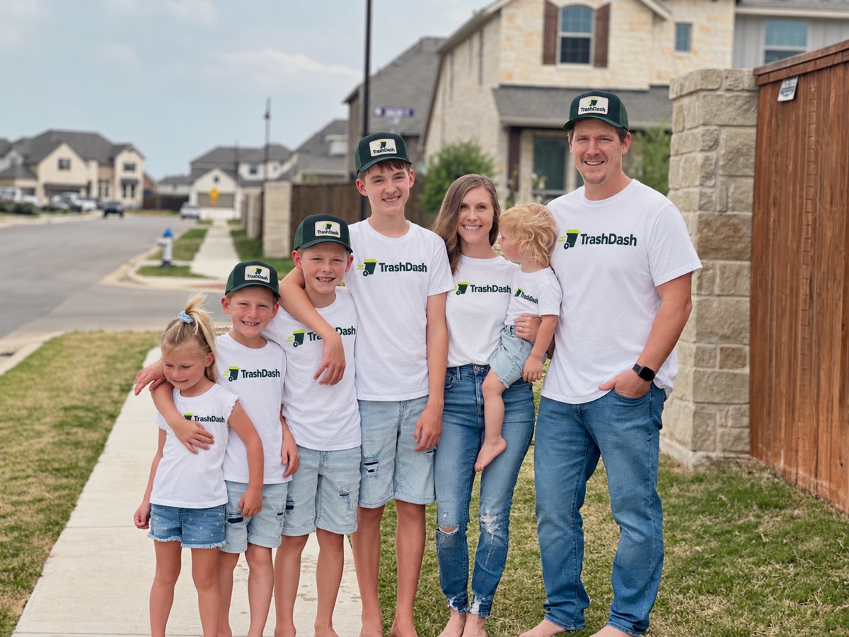 The family behind TrashDash in branded shirts and caps